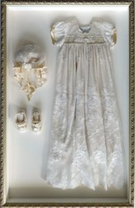 Custom framing_shadowbox_christening dress_hat and booties_Westwood Gallery